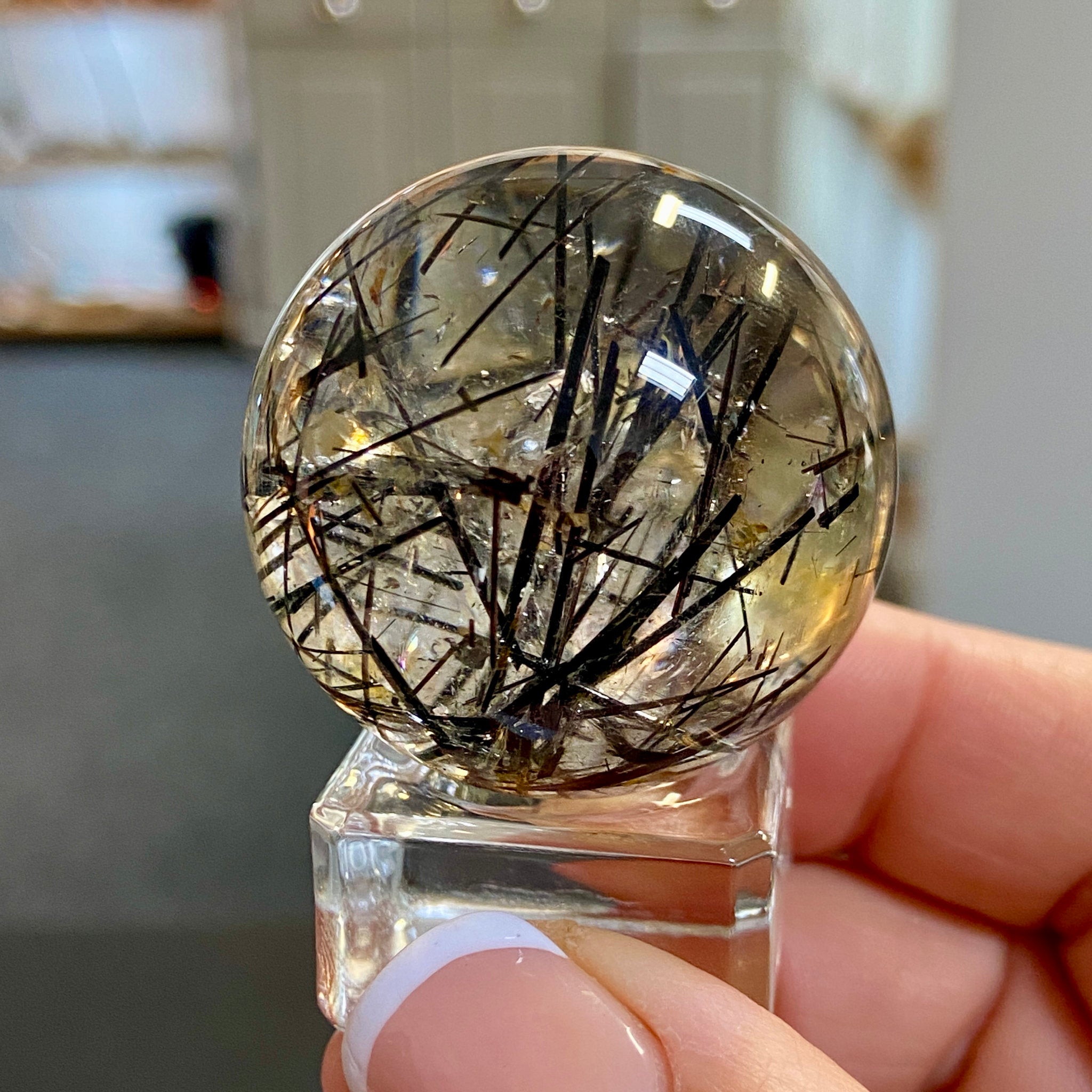 Clear Quartz Sphere with Black Tourmaline and Iron Inclusions
