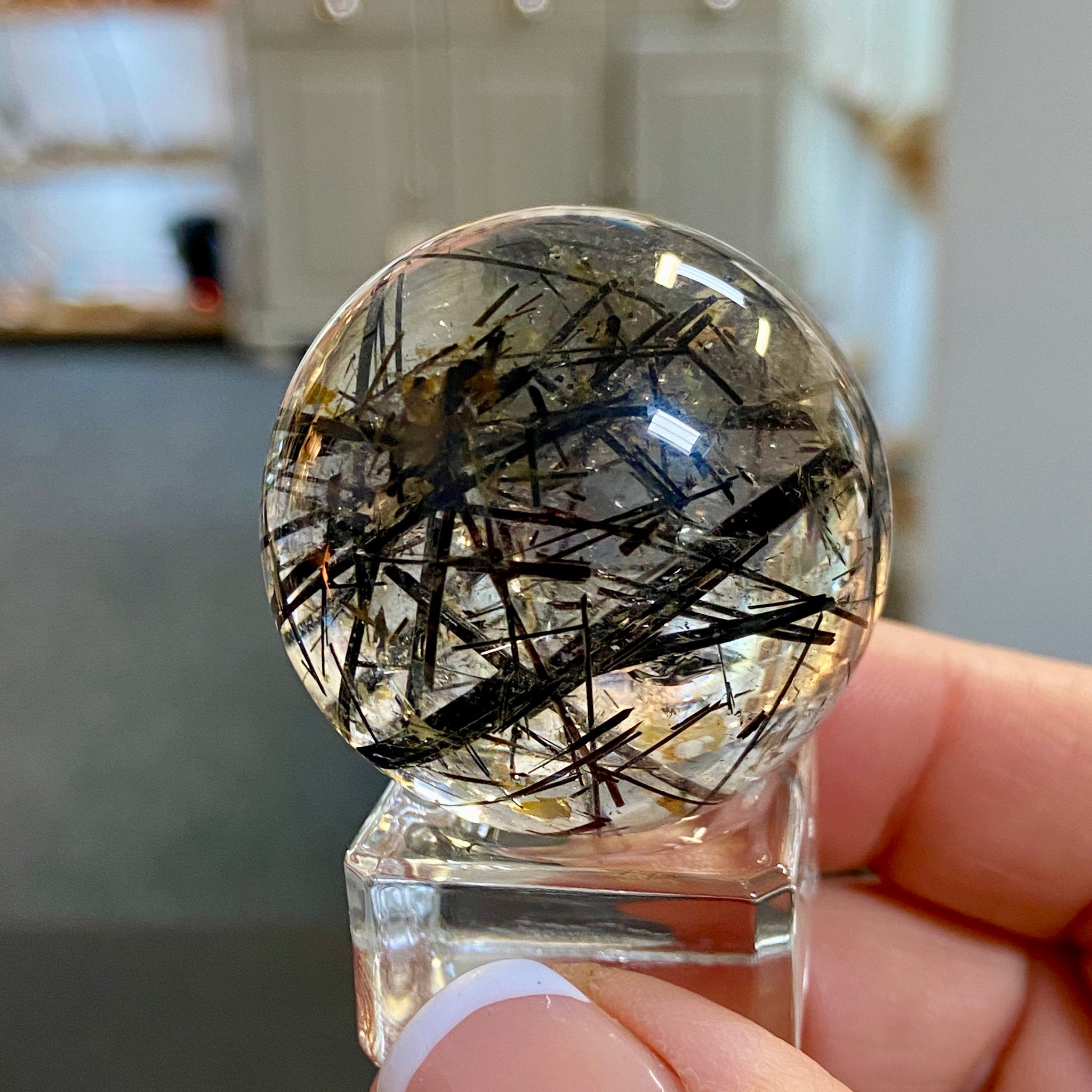 Clear Quartz Sphere with Black Tourmaline and Iron Inclusions