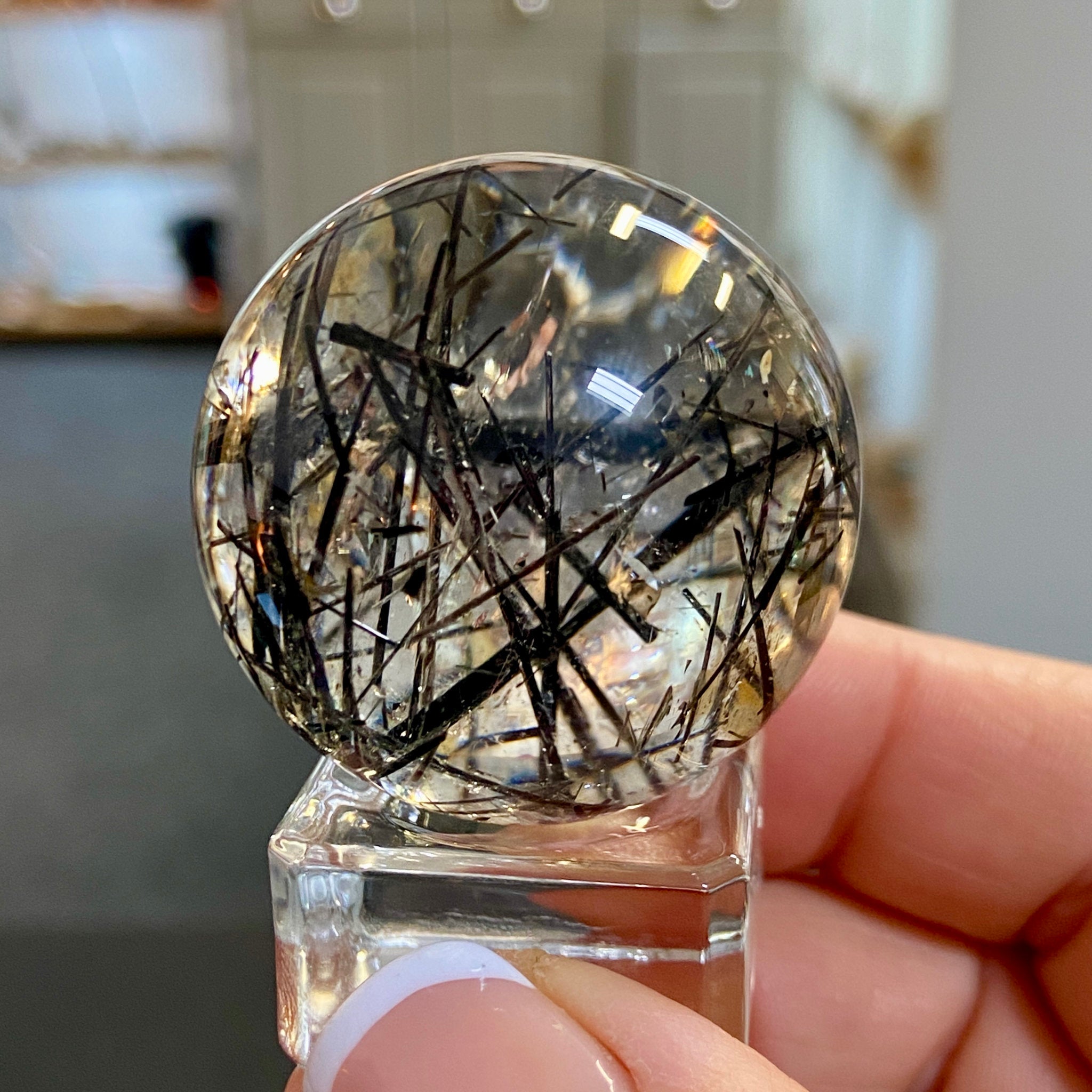 Clear Quartz Sphere with Black Tourmaline and Iron Inclusions