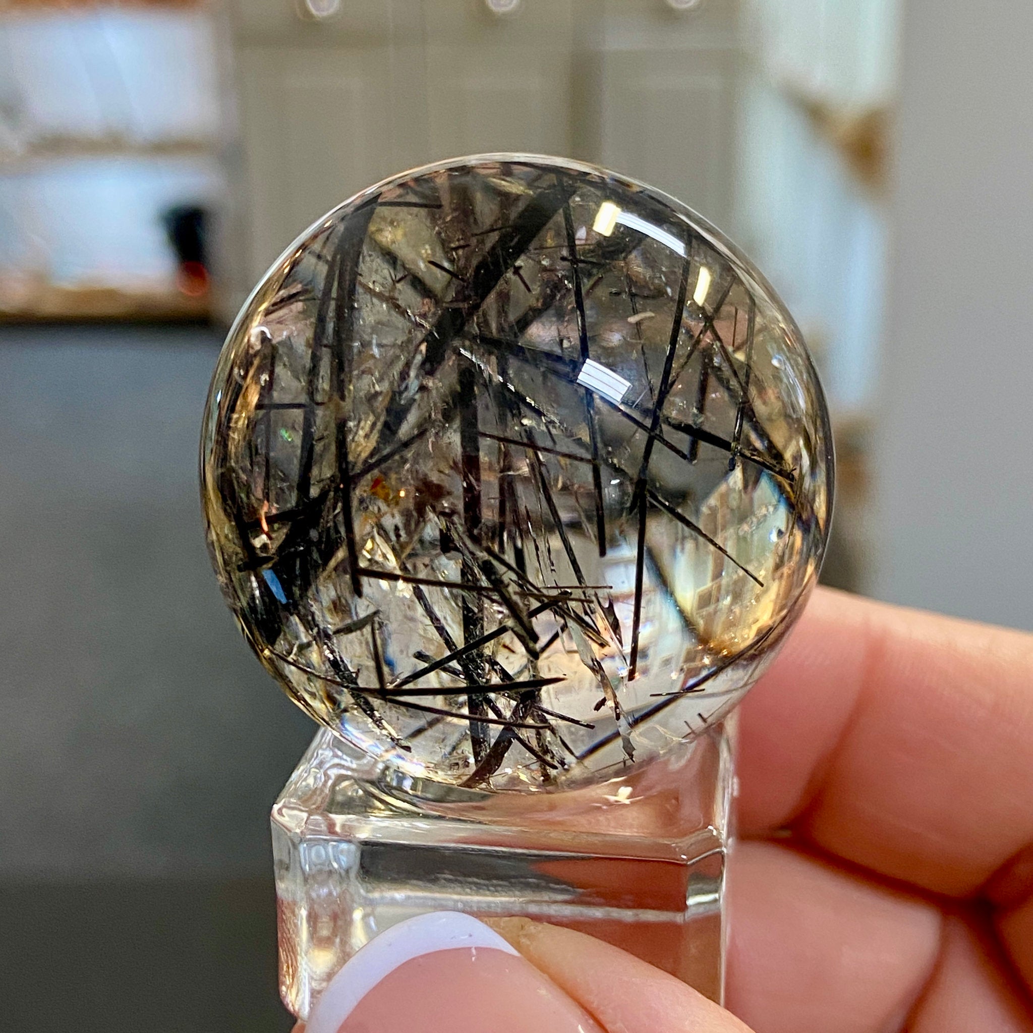 Clear Quartz Sphere with Black Tourmaline and Iron Inclusions